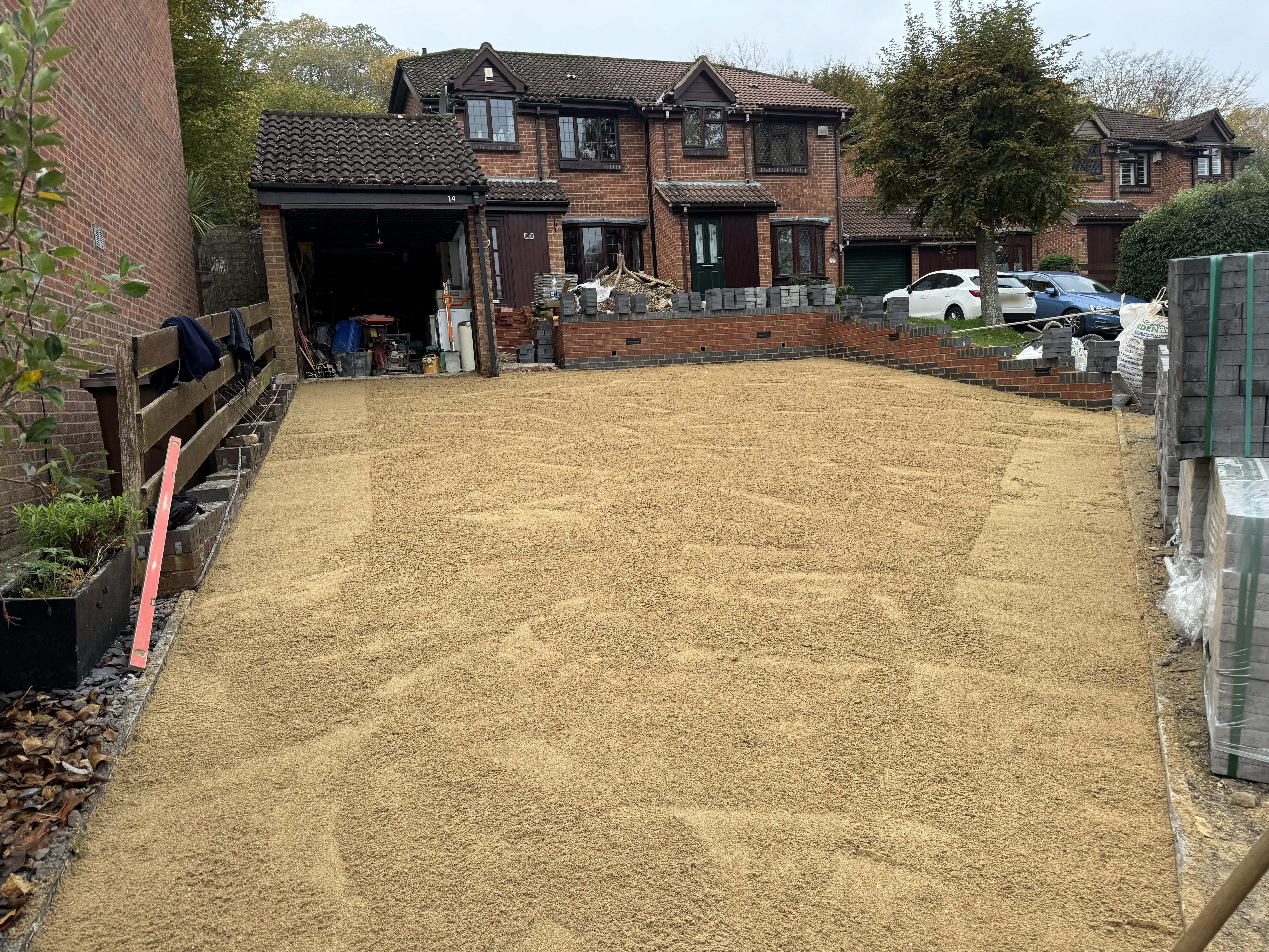 Levelled sub-base with retaining walls for block paving driveway Kent