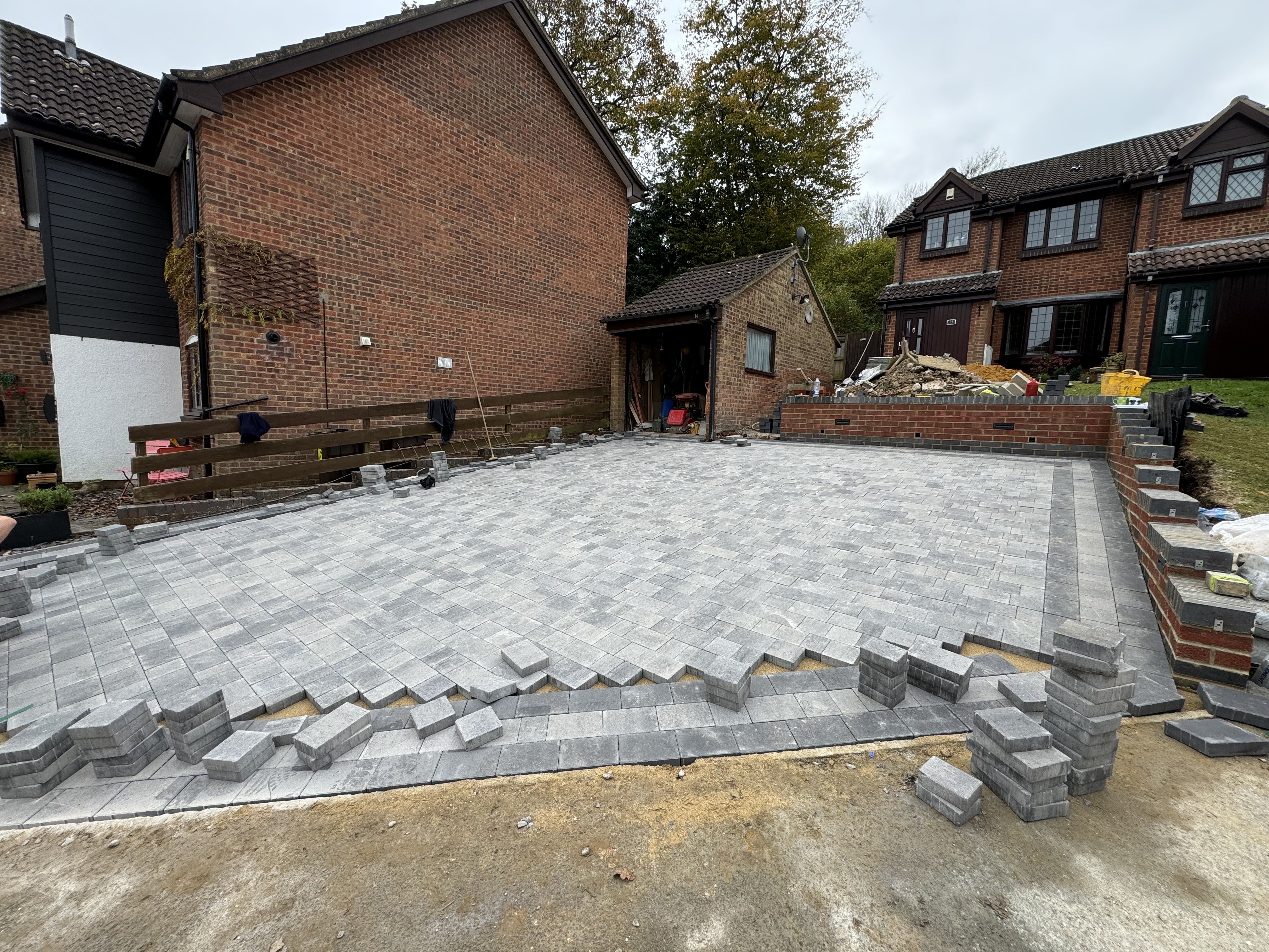 Block paving installation in progress with interlocking pattern Kent