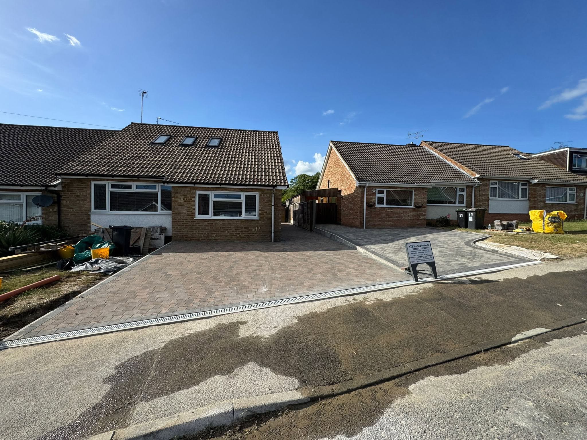 Two new block paving driveways side by side in Burham, Medway - Brett Omega Silver Haze on the left and Brett Trio Burnt Oak with charcoal border on the right