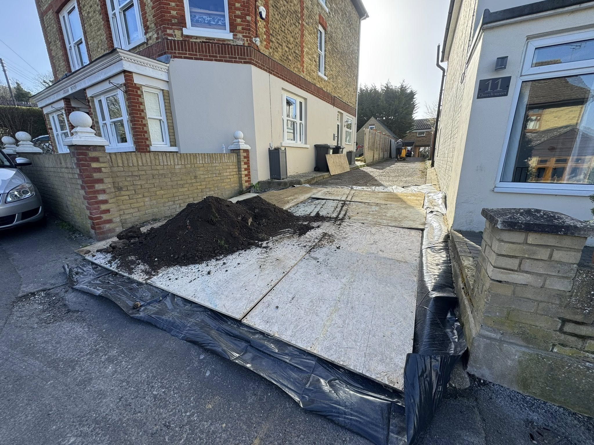 Front driveway boarded for muckaway and material deliveries during block paving installation in Canterbury