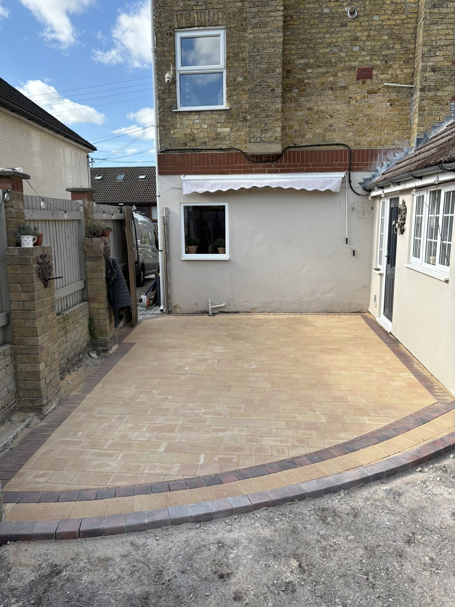 Castacrete mellow yellow block paving rear garden with brindle border at a Canterbury Victorian semi