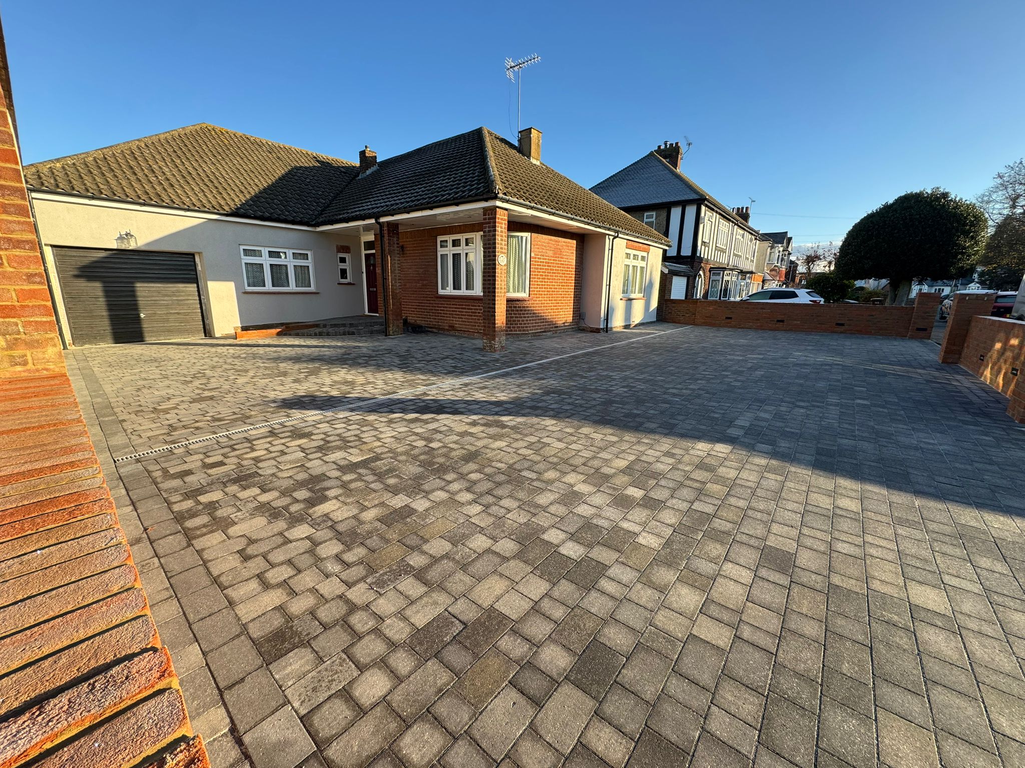 Integrated LED lighting in brick retaining wall for driveway security Rochester