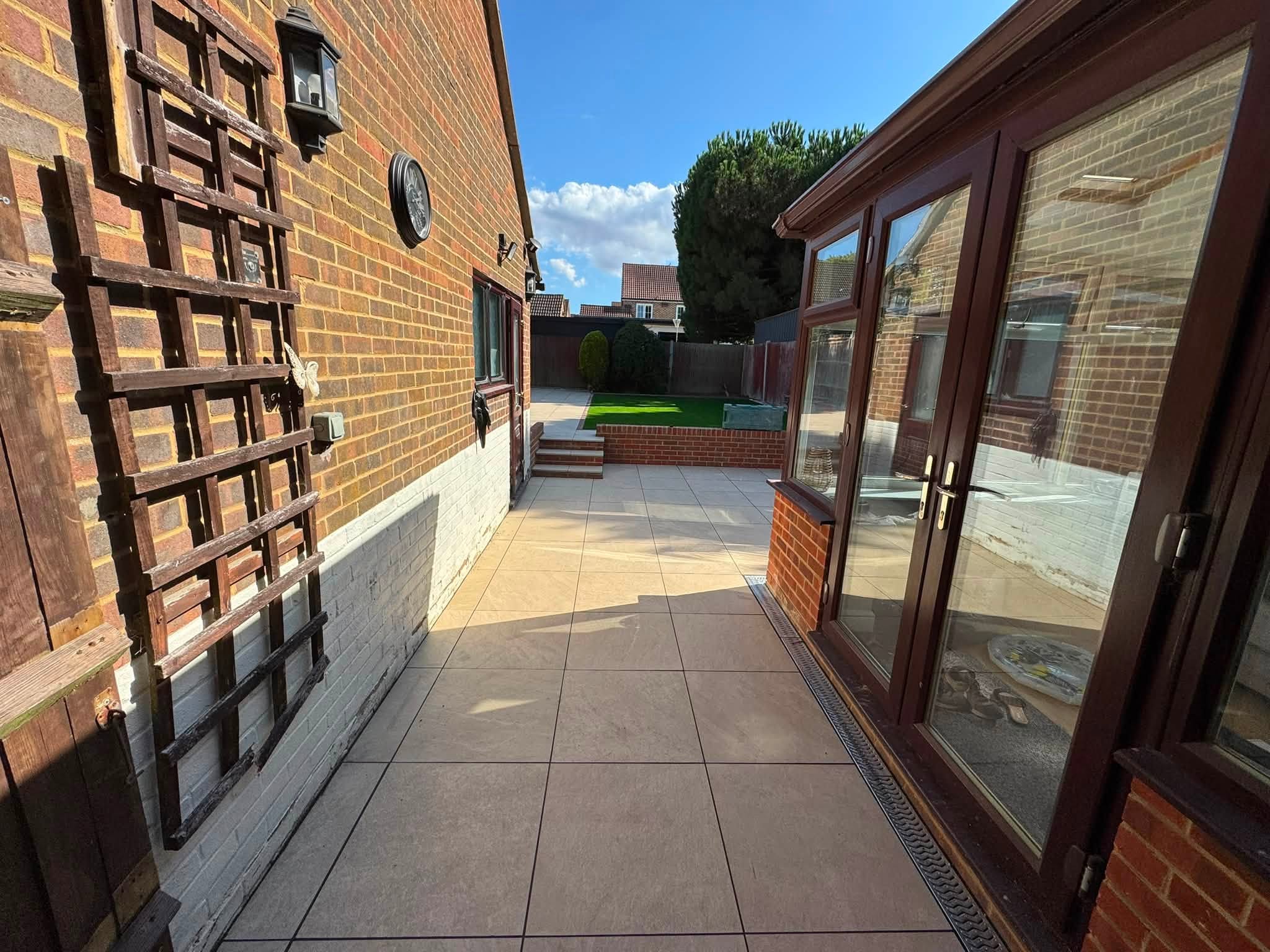 Aura Beige porcelain side return with ACO channel beside French doors in Hempstead, Gillingham