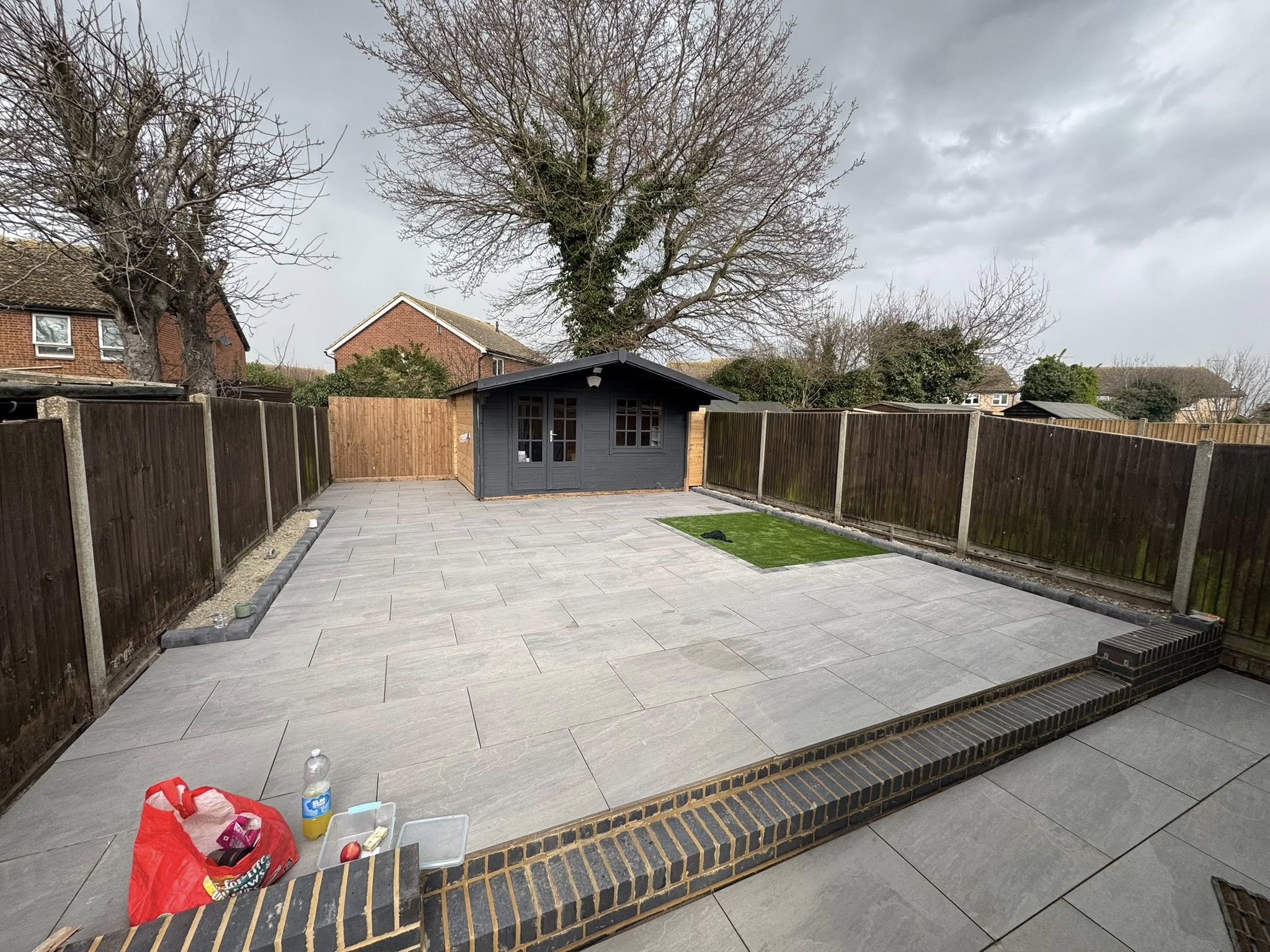 Herne Bay complete garden makeover rear view with porcelain patio and summerhouse
