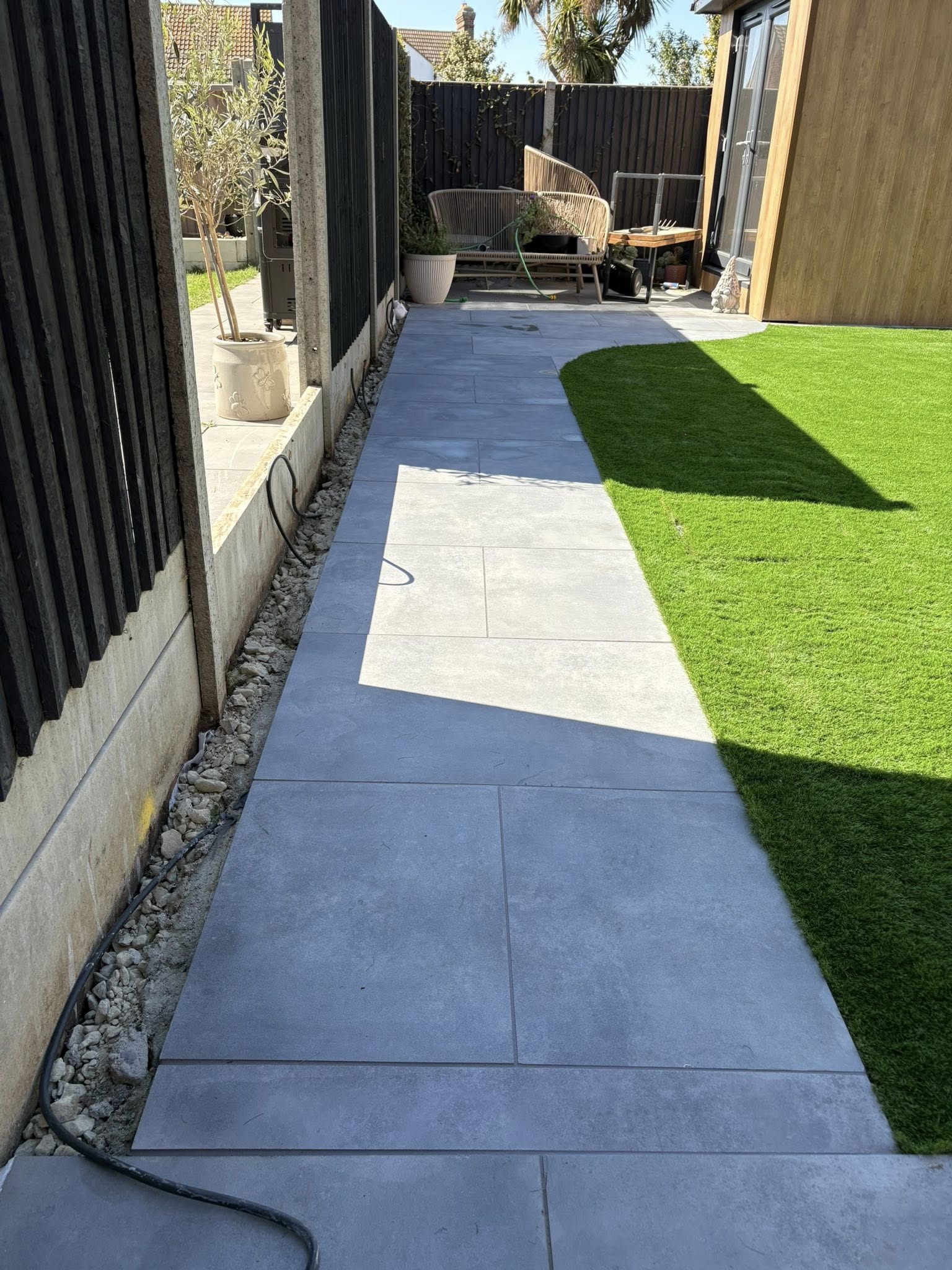 Curved 600x900mm porcelain footpath with gravel border and planting in a Maidstone garden