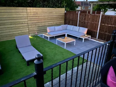 Modern Garden with Artificial Grass and Sleek Wooden Fence