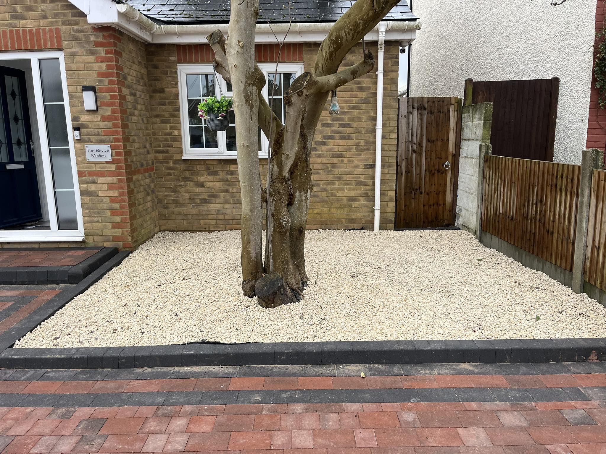 Tree landscaping with decorative stones for red brick block paving driveway Rochester