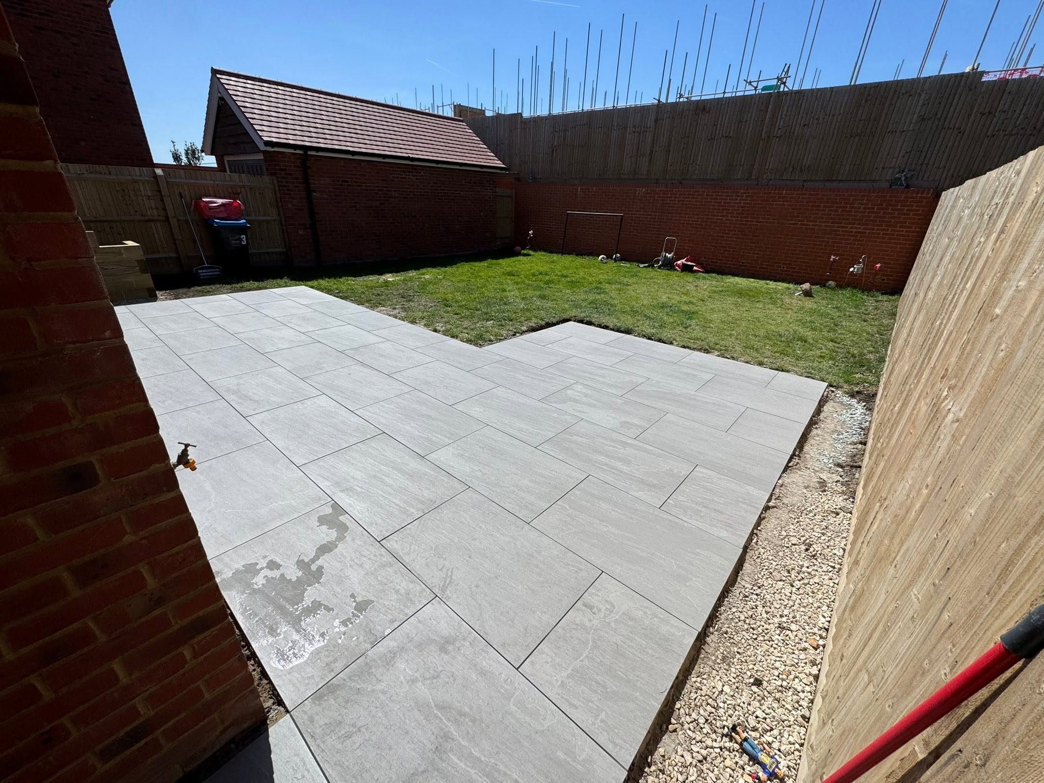 Kandla Grey porcelain patio in Sevenoaks meeting the lawn with clean edges and no retaining walls