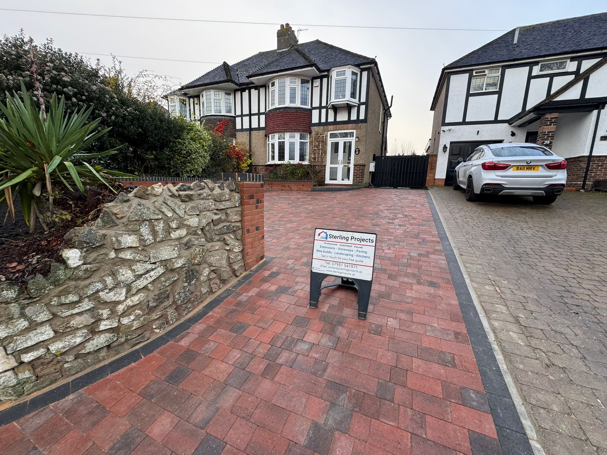 Complete red brick block paving driveway transformation with retaining wall, black border and drainage Rochester