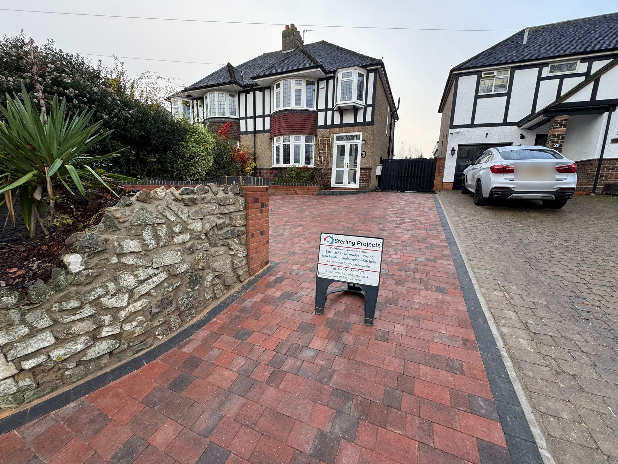 Complete red brick block paving driveway transformation with retaining wall, black border and drainage Rochester